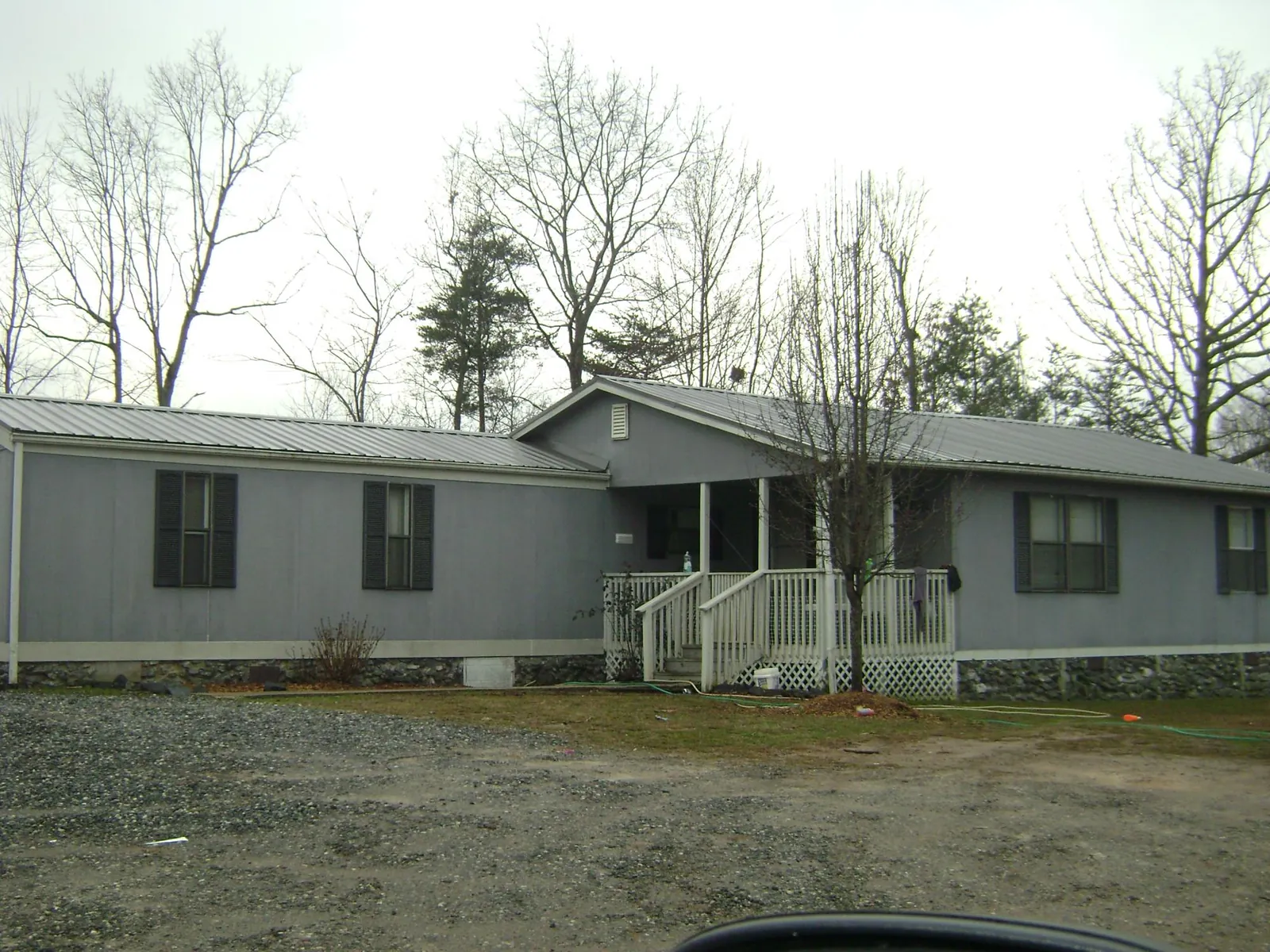 Metal roof over a manufactured home with a covered front porch in Rockport